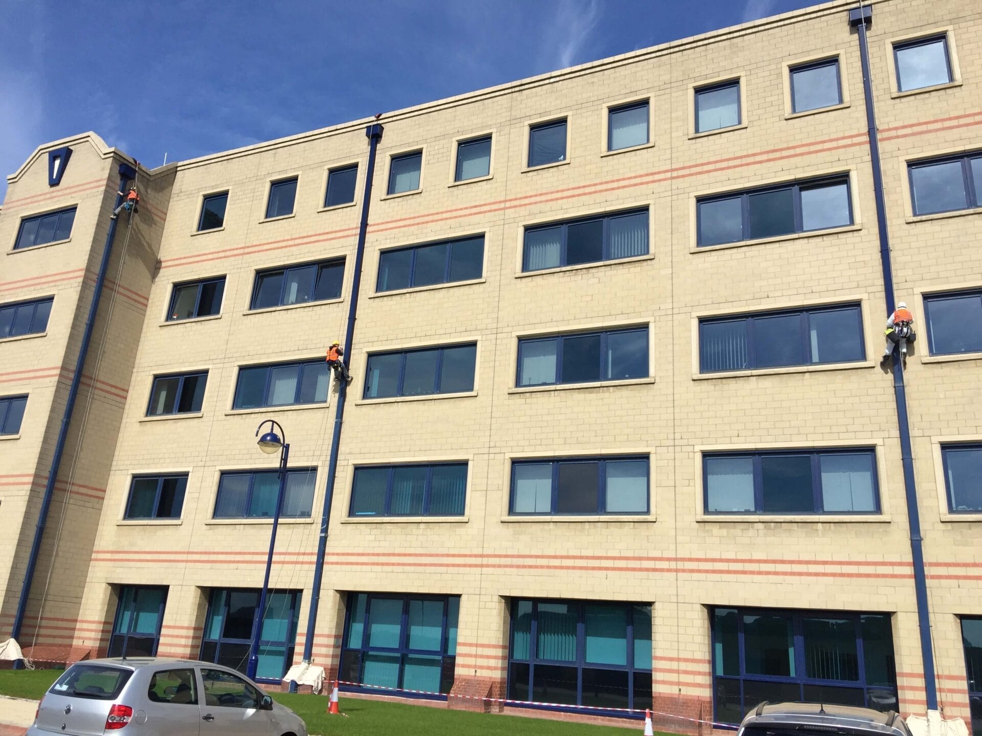 A large building with a car parked in front of it, captured in a stunning painting.